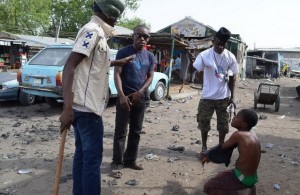 Civilian JTF interrogate a suspected Boko Haram informant