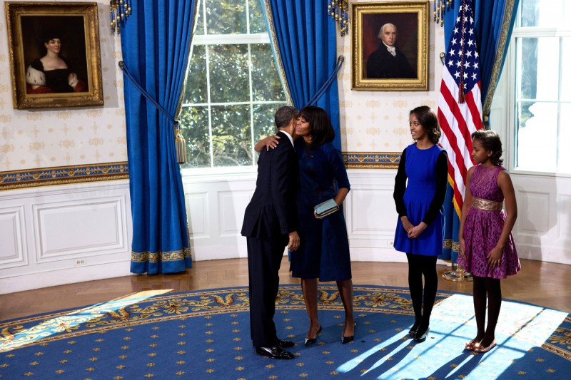 U.S President Barack Obama (L) takes the oath of office as first lady Michelle Obama holds the bible in the Blue Room of the White House in Washington