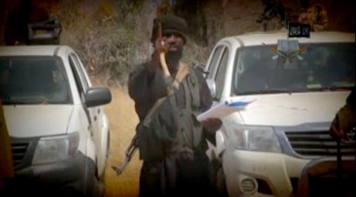 (FILES)- In this screen grab image taken on February 9, 2015 from a video made available by Islamist group Boko Haram, leader Abubakar Shekau makes a statement at an undisclosed location. Eclipsed by newer, more bloodthirsty and media-savvy global jihadists, Somalia's Shebab militants are struggling to stay relevant. On March 7, 2015 the two most rapidly ascendant militant Islamist groups joined forces, in words at least, as Nigeria's Boko Haram declared its allegiance to the Islamic State (IS) in Iraq and Syria. The rise of these two groups has left Al-Qaeda aligned Shebab in the dust, damaging its capacity to attract foreign recruits, said Ken Menkhaus, a Somalia expert and professor at Davidson College, North Carolina. AFP PHOTO / BOKO HARAM =RESTRICTED TO EDITORIAL USE - MANDATORY CREDIT "AFP PHOTO / BOKO HARAM" - NO MARKETING NO ADVERTISING CAMPAIGNS - DISTRIBUTED AS A SERVICE TO CLIENTS