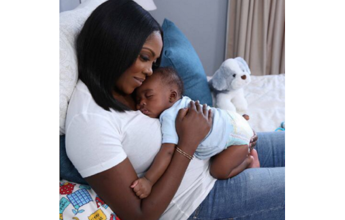 Tiwa Savage shares lovely picture of son asleep in her arms theinfong.com 700x446