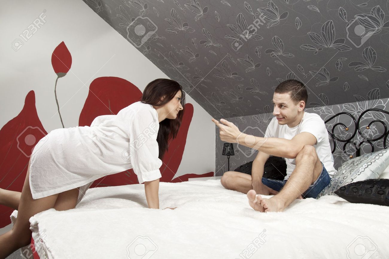 16382458-Young-guy-lures-the-girl-to-bed-by-his-finger-Stock-Photo-couple-sexy-romantic