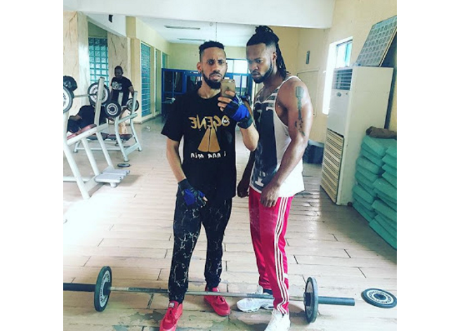 Flavour flaunts bulging muscles at the Gym; Pictured with Phyno See Photos