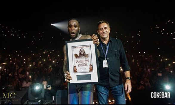 Burna Boy had a great night yesterday November 3, as he became the first Afrobeat artiste to sell out the SSE Arena asides winning the “Best African Act’ Award at the star-studded 2019 MTV EMA held in Seville, Spain. The sold out concert which was held at the 12,500-seat SSE Arena also had Davido, Dave, M.anifest,ij Wstrn and Stormzy performing. Here is a photo of Burna Boy receiving a plaque over the sold-out concert and videos from the event;