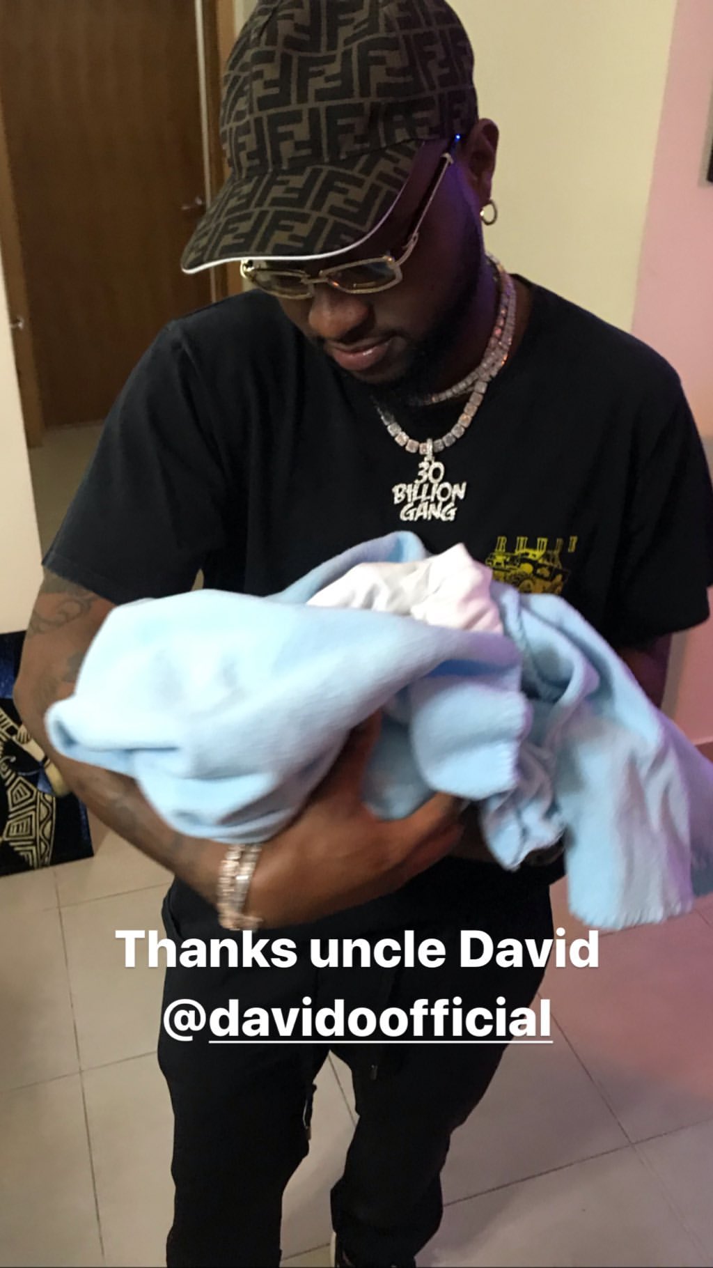 Davido visits B-red, pictured carrying his newborn son (Photos)