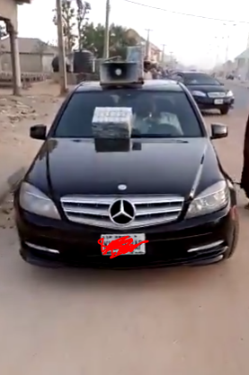 Viral video of a Nigerian man selling 'hausa' herbs by the roadside in Mercedes Benz C-class (Video)