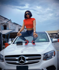 “Life is tough when everyone is watching your next move” – Mercy Eke says as she poses on her Benz in new photos