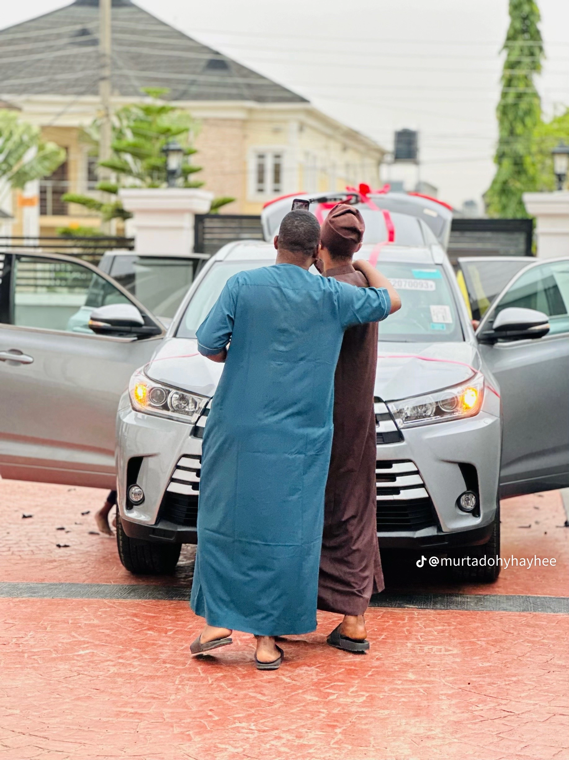 Heartwarming moment as Nigerian wife kneels in thanks as husband gifts new car