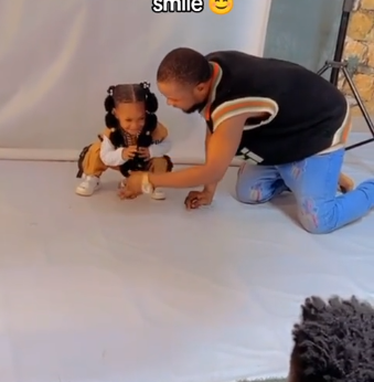 Father melts heart as he does stunts to make daughter smile during photoshoot