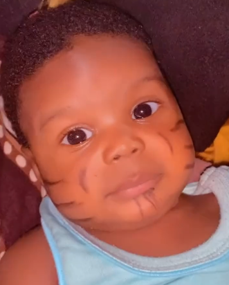 “I pray this is not real” – Reactions as Nigerian lady shows off newborn baby’s tribal marks