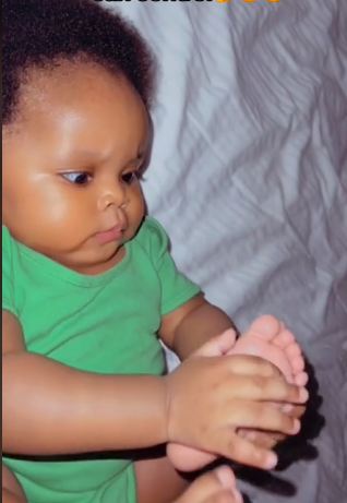 Adorable moment baby discovers she is born with hands and legs