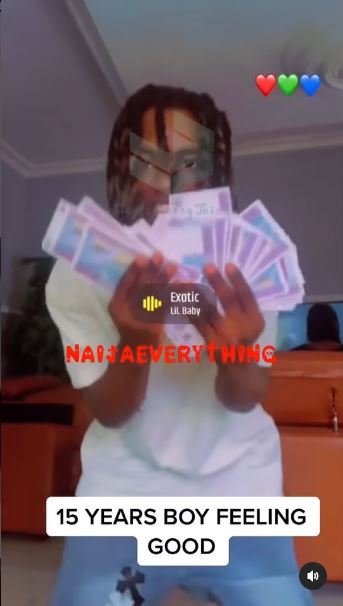 15-year-old boy shows off stash of cash from his ritual activities