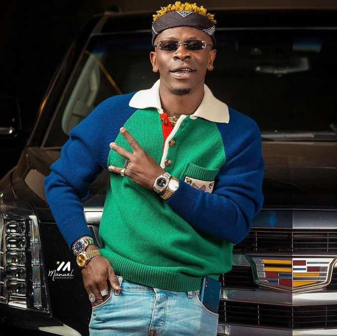 Shatta Wale dragged after kissing male bodyguard on the lips